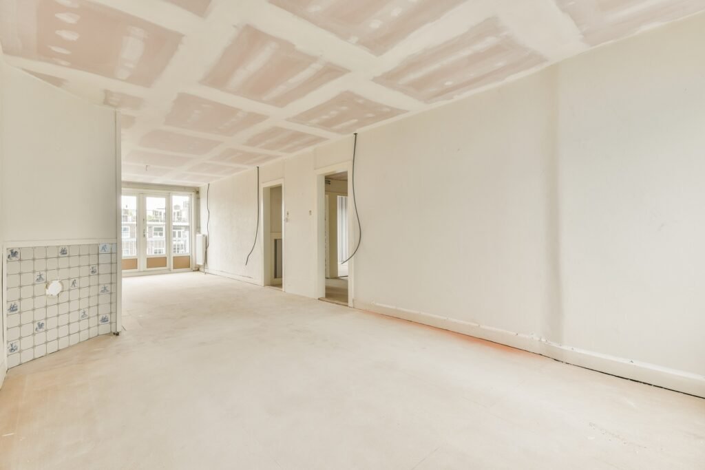 Empty room with windows and radiator in daylight